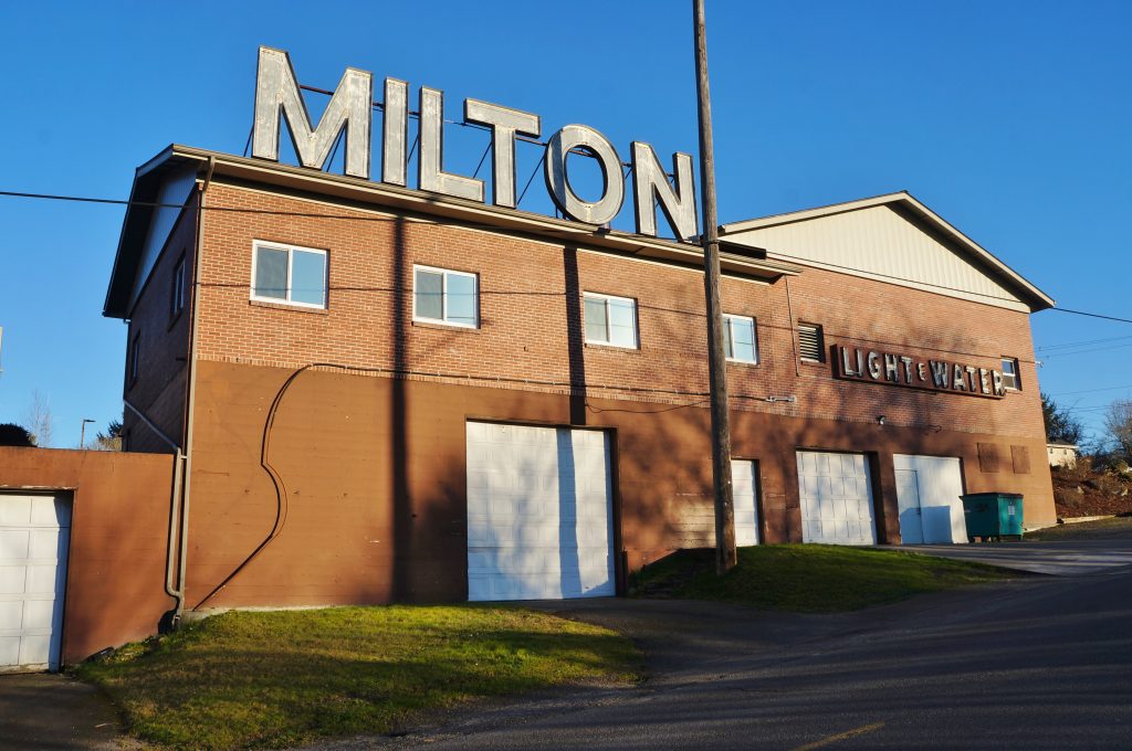 Historic Milton Light and Water building with large rooftop MILTON sign